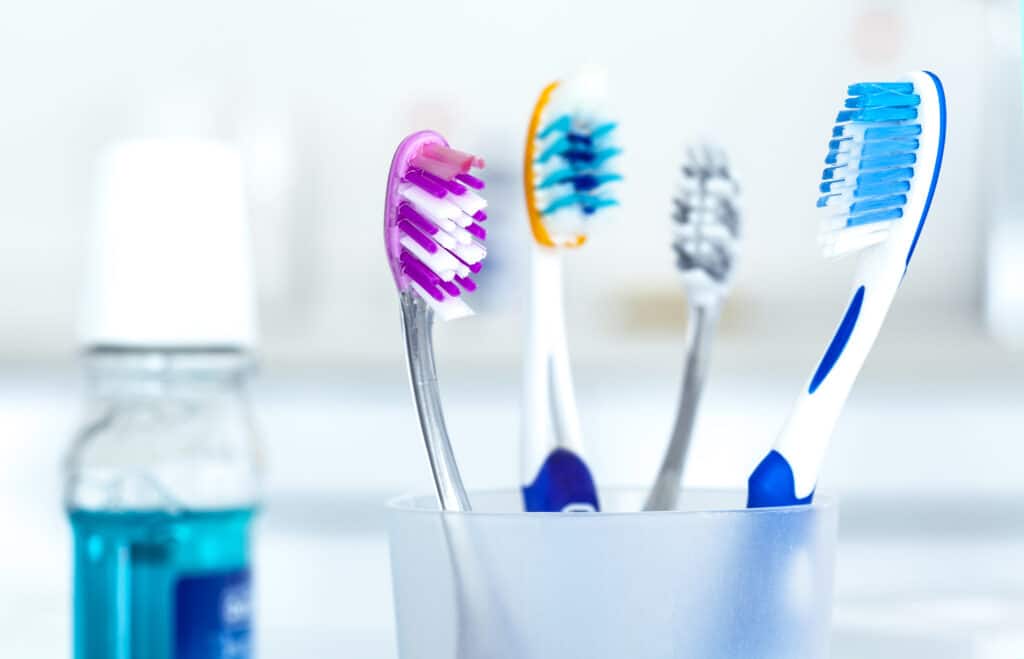 tooth brushes in a cup What Are Your Toothbrush Bristles Telling You? DR. Justin Moseley. Moseley Dental Group. General, Cosmetic, Restorative, Preventative Dentistry Dentist in Dallas TX 752253